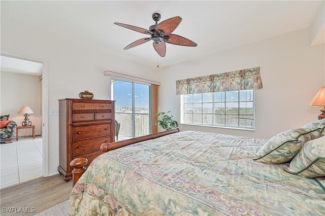 bedroom featuring access to exterior, ceiling fan, and light hardwood / wood-style flooring