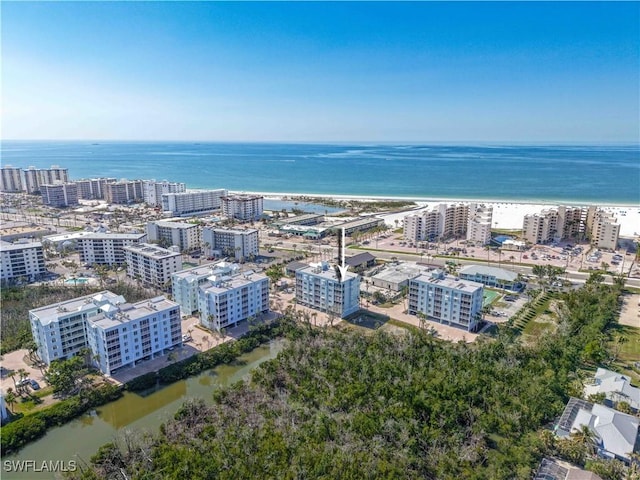 bird's eye view with a water view and a beach view