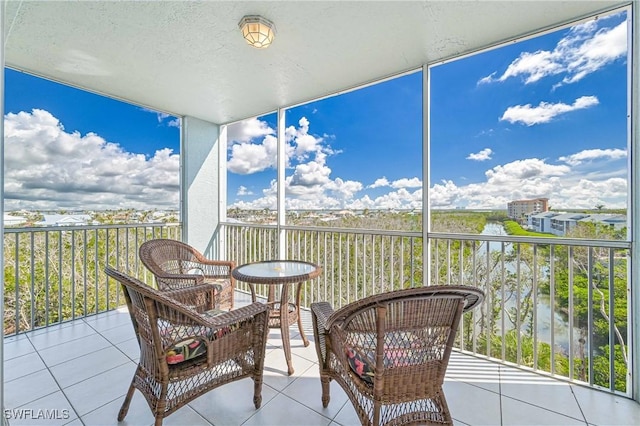 sunroom / solarium featuring a water view