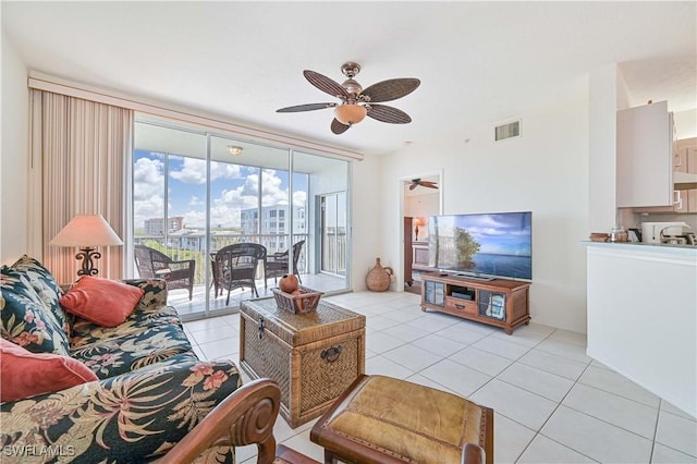 living room featuring floor to ceiling windows, light tile patterned floors, and ceiling fan