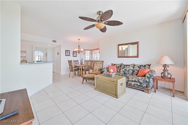 tiled living room featuring ceiling fan with notable chandelier