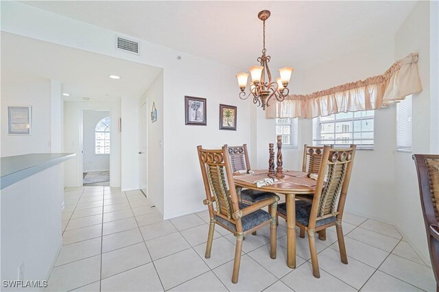 tiled dining space with a chandelier and a wealth of natural light