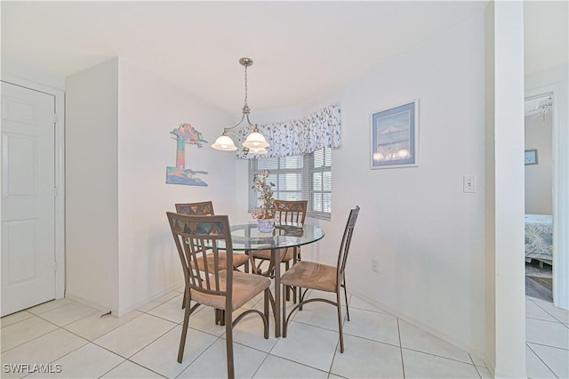 dining room with light tile patterned floors and a chandelier