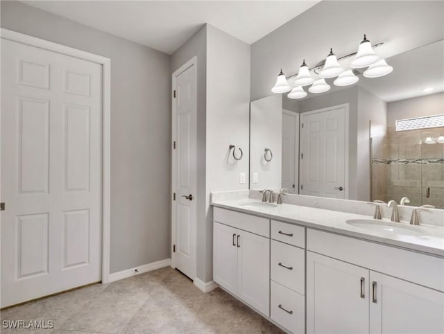 bathroom with tile patterned floors, vanity, and a shower with door