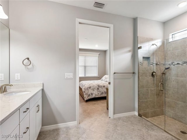 bathroom featuring tile patterned flooring, vanity, and an enclosed shower