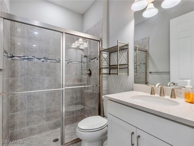 bathroom with vanity, walk in shower, and toilet