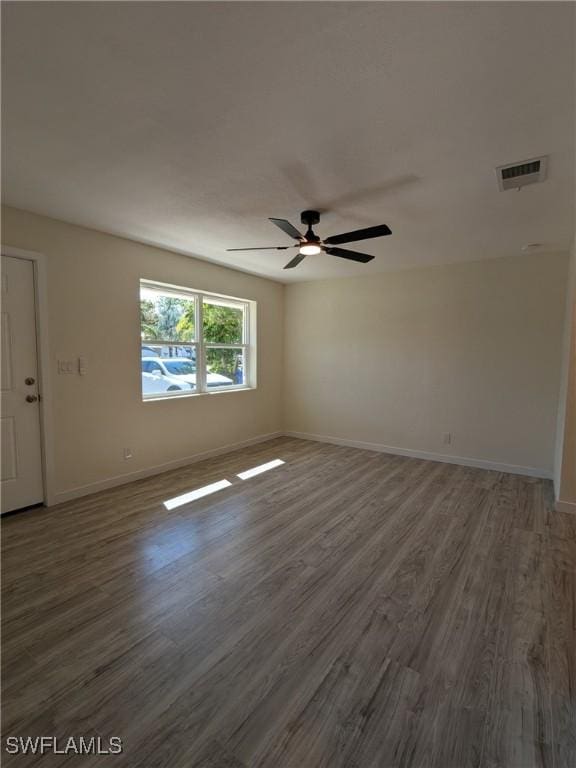 empty room featuring ceiling fan and dark hardwood / wood-style floors