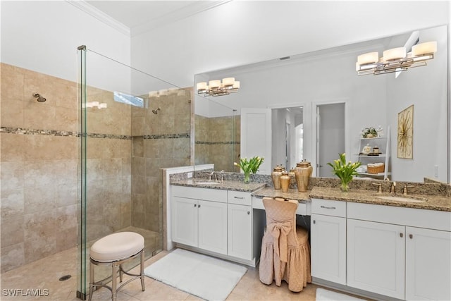 bathroom featuring a stall shower, ornamental molding, tile patterned floors, vanity, and a chandelier