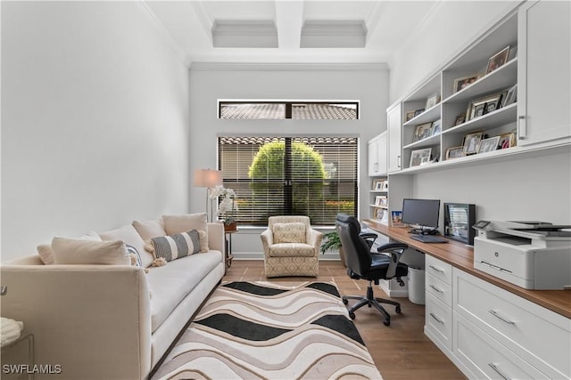 office with coffered ceiling, wood finished floors, beam ceiling, built in desk, and crown molding