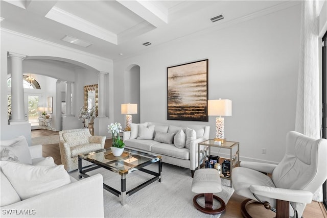 living room with arched walkways, beam ceiling, visible vents, ornamental molding, and ornate columns