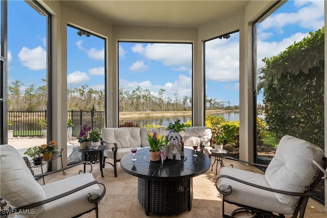 sunroom featuring a water view and a healthy amount of sunlight