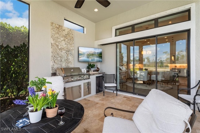 view of patio with exterior kitchen, grilling area, and a ceiling fan