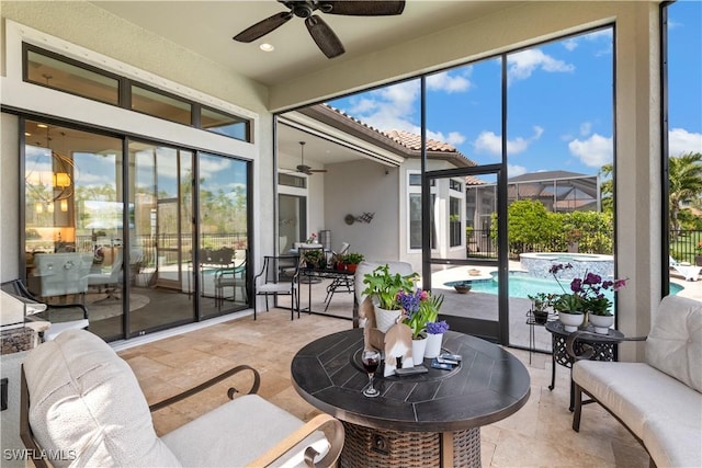 sunroom / solarium with a ceiling fan