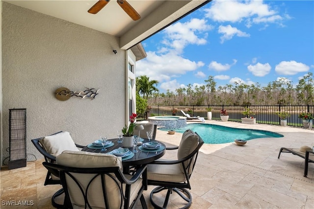 view of pool with a patio area, a fenced backyard, a pool with connected hot tub, and a ceiling fan