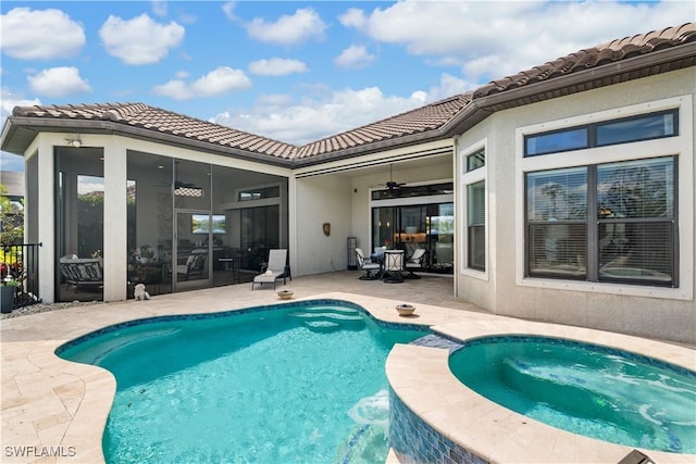 back of house featuring a ceiling fan, a patio, a tile roof, a pool with connected hot tub, and stucco siding