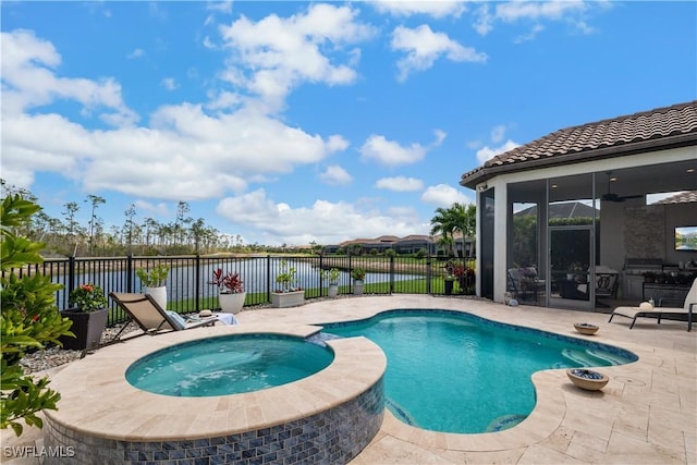 view of pool featuring a patio, a pool with connected hot tub, a water view, a ceiling fan, and a fenced backyard