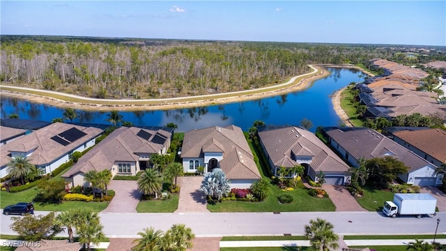 aerial view with a residential view, a water view, and a wooded view