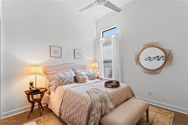 bedroom featuring ornamental molding, baseboards, and wood finished floors