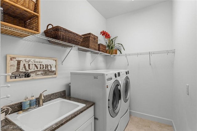 laundry room featuring laundry area, a sink, and separate washer and dryer