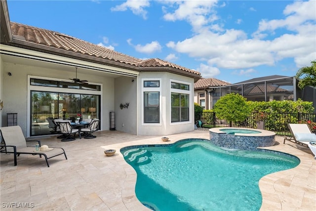 view of pool with a patio, glass enclosure, fence, a ceiling fan, and outdoor dining space