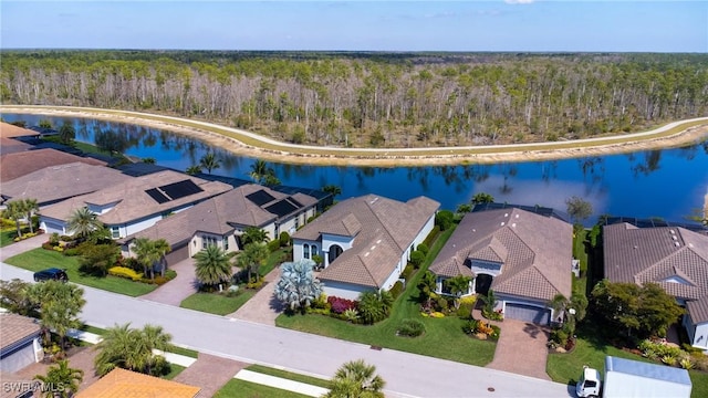 aerial view with a water view, a forest view, and a residential view