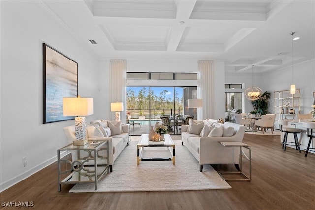 living area with visible vents, coffered ceiling, baseboards, and wood finished floors