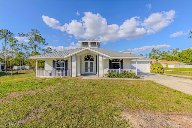 view of front facade with a garage, a front yard, and covered porch