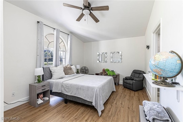 bedroom featuring vaulted ceiling, ceiling fan, and light hardwood / wood-style floors