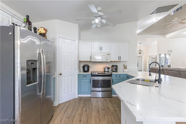 kitchen featuring sink, light wood-type flooring, white cabinets, and appliances with stainless steel finishes