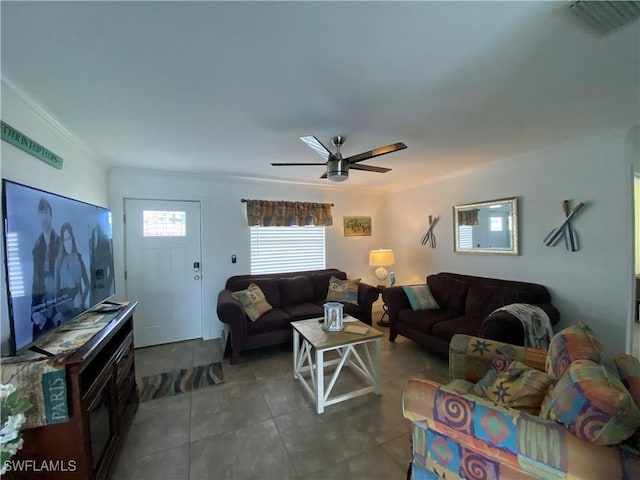 tiled living room featuring ceiling fan and crown molding