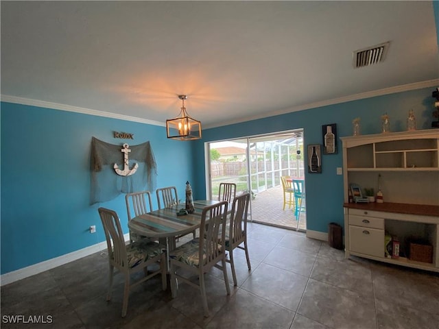 dining area featuring an inviting chandelier, baseboards, visible vents, and ornamental molding