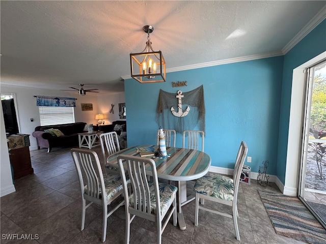 dining room with baseboards, ceiling fan with notable chandelier, and crown molding