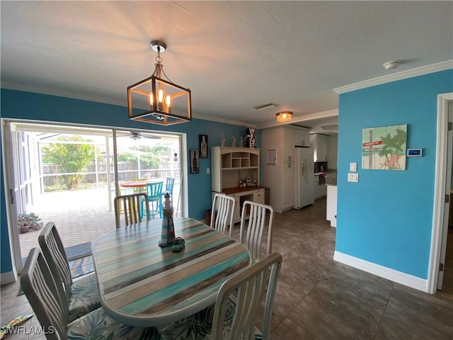 dining room with ornamental molding, an inviting chandelier, visible vents, and baseboards