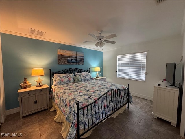 bedroom with baseboards, visible vents, and ceiling fan