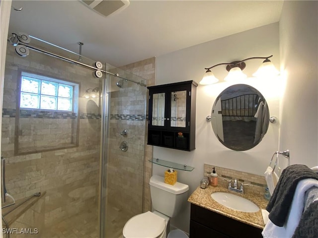 bathroom featuring visible vents, backsplash, toilet, a shower stall, and vanity