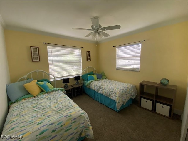 carpeted bedroom featuring multiple windows, ornamental molding, and a ceiling fan