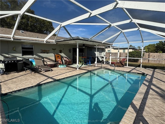 view of swimming pool with a fenced in pool, grilling area, a lanai, fence, and a patio area