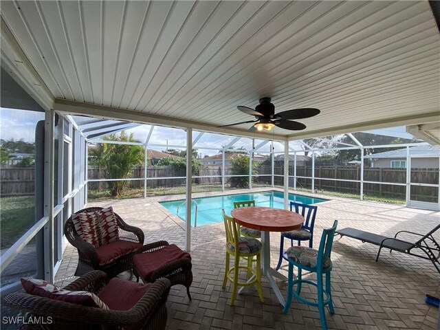 view of pool with a ceiling fan, a fenced in pool, a patio, a fenced backyard, and a lanai