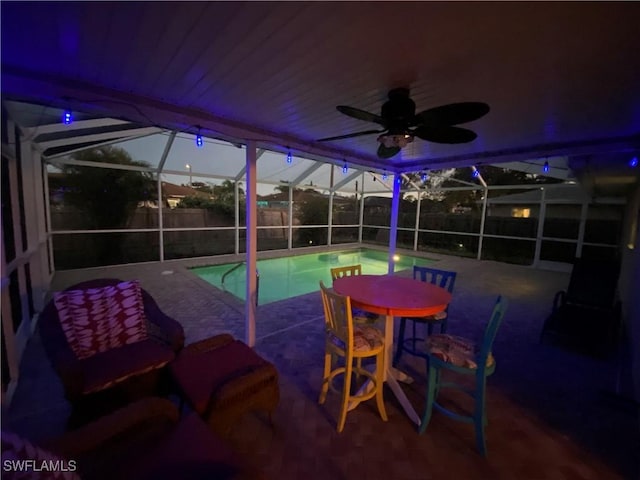 view of patio / terrace featuring a fenced in pool, glass enclosure, a fenced backyard, and ceiling fan