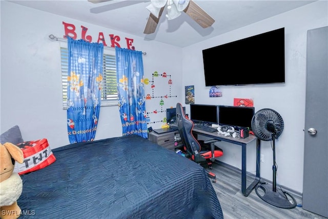 bedroom with ceiling fan and wood-type flooring