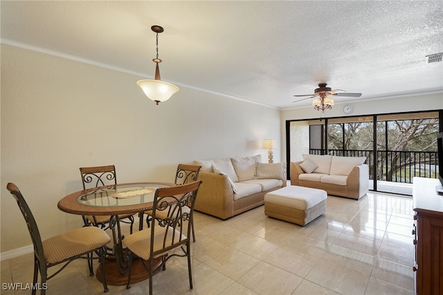 living room with ceiling fan, crown molding, a textured ceiling, and light tile patterned flooring