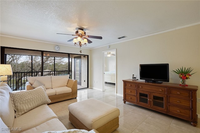 living room with ornamental molding, light tile patterned flooring, ceiling fan, and a textured ceiling