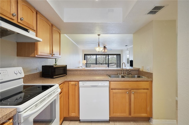 kitchen featuring pendant lighting, sink, white appliances, and ornamental molding