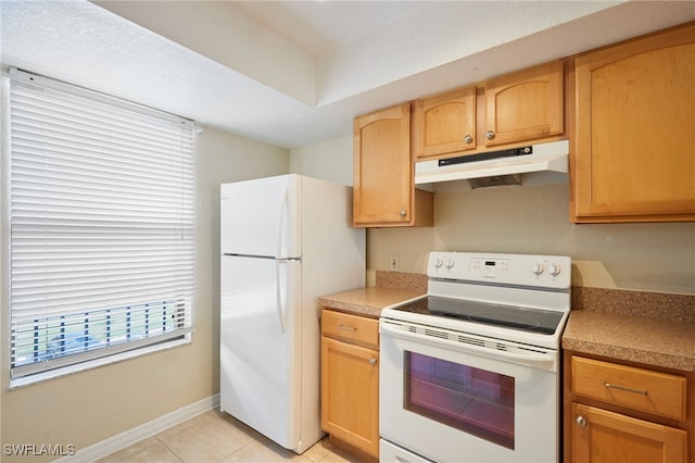 kitchen featuring light tile patterned floors and white appliances