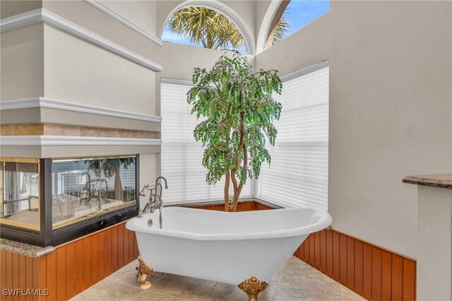 bathroom with tile patterned flooring and a washtub