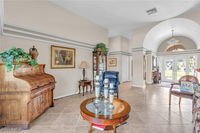 living area featuring light tile patterned floors and french doors