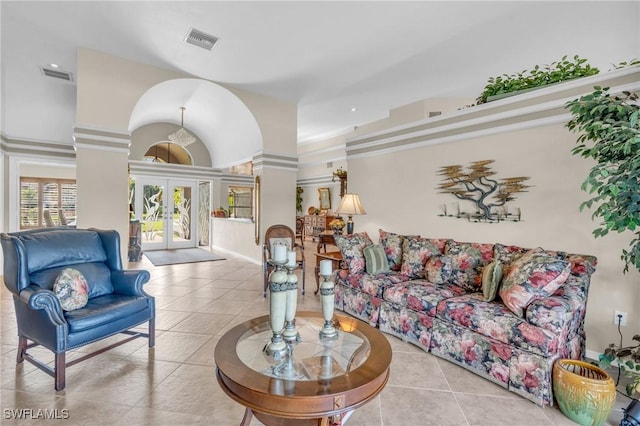 tiled living room featuring french doors