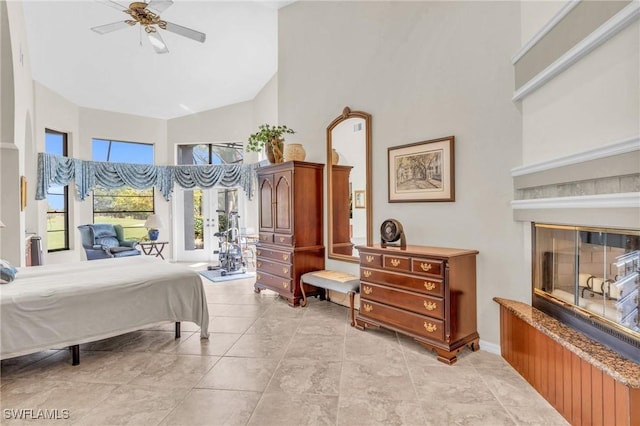 bedroom with ceiling fan and a high ceiling