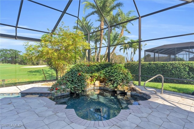 view of pool featuring a patio area, glass enclosure, and a lawn