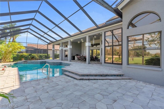 view of swimming pool featuring a lanai, a patio, and ceiling fan